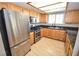 Efficient kitchen featuring stainless steel appliances, wooden cabinetry and granite countertops at 9408 Amber Valley Ln, Las Vegas, NV 89134