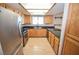 Efficient kitchen featuring stainless steel appliances, granite countertops and wooden cabinetry at 9408 Amber Valley Ln, Las Vegas, NV 89134