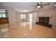 Open-concept living space featuring hardwood floors, fireplace, ceiling fan and sliding glass doors at 9408 Amber Valley Ln, Las Vegas, NV 89134