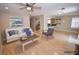 Open-concept room, virtually staged, with light wood floors and natural light at 9408 Amber Valley Ln, Las Vegas, NV 89134