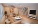 Bright living room with a comfortable beige sofa, chair, and stylish decor, virtually staged at 9408 Amber Valley Ln, Las Vegas, NV 89134