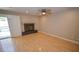 Inviting living area featuring a fireplace, hardwood floors, ceiling fan and sliding glass doors at 9408 Amber Valley Ln, Las Vegas, NV 89134