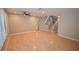 Open-concept living area featuring hardwood floors, ceiling fan, stairway and large window for natural light at 9408 Amber Valley Ln, Las Vegas, NV 89134