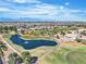 Beautiful aerial view of community with golf course, walking path, and water feature at 9513 Villa Ridge Dr, Las Vegas, NV 89134