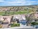 Expansive aerial view of a charming community nestled around a beautiful golf course, showcasing a desirable lifestyle at 9513 Villa Ridge Dr, Las Vegas, NV 89134