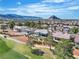 High aerial of golf course homes, desert landscaping and mountain views in the distance at 9513 Villa Ridge Dr, Las Vegas, NV 89134