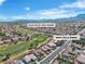 Beautiful aerial view of community with golf course, water feature, and mountain views at 9513 Villa Ridge Dr, Las Vegas, NV 89134