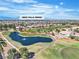 Beautiful aerial view of community with golf course, walking path, and water feature at 9513 Villa Ridge Dr, Las Vegas, NV 89134