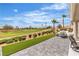 Backyard featuring a covered patio and golf course views, complete with outdoor seating and desert landscaping at 9513 Villa Ridge Dr, Las Vegas, NV 89134