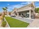 Stunning backyard patio with a built-in grill, a cozy seating area, and manicured landscaping for luxurious outdoor living at 9513 Villa Ridge Dr, Las Vegas, NV 89134