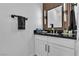 Contemporary bathroom showcasing wood paneling, a black countertop, and a modern sink at 9513 Villa Ridge Dr, Las Vegas, NV 89134