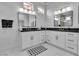 Elegant bathroom featuring dual sinks, black countertops, and modern fixtures at 9513 Villa Ridge Dr, Las Vegas, NV 89134