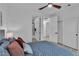 Comfortable bedroom view featuring a full bed, ensuite bathroom, and walk-in closet with sleek white doors at 9513 Villa Ridge Dr, Las Vegas, NV 89134