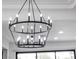 Elegant two-tiered chandelier with candle-style lights illuminates the modern space at 9513 Villa Ridge Dr, Las Vegas, NV 89134