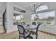 Elegant dining area with golf course views, sleek seating, and floor-to-ceiling windows for natural light at 9513 Villa Ridge Dr, Las Vegas, NV 89134