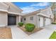 Exterior view showcasing a well-maintained lawn, mature shrubs, and a three-car garage at 9513 Villa Ridge Dr, Las Vegas, NV 89134