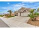 Home with desert landscaping and a long driveway, complemented by mature palm trees at 9513 Villa Ridge Dr, Las Vegas, NV 89134