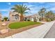 Well-maintained front yard with desert landscaping and palm trees enhancing curb appeal at 9513 Villa Ridge Dr, Las Vegas, NV 89134