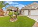 Beautiful front yard with lush synthetic grass, mature palm trees, and manicured desert landscaping at 9513 Villa Ridge Dr, Las Vegas, NV 89134