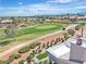 Breathtaking aerial view showcasing the lush golf course and the surrounding community with scenic mountain views at 9513 Villa Ridge Dr, Las Vegas, NV 89134