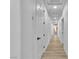 Long hallway with multiple doorways and sleek hardwood flooring at 9513 Villa Ridge Dr, Las Vegas, NV 89134
