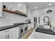 Bright kitchen with stainless steel appliances, subway tile backsplash, and white cabinetry at 9513 Villa Ridge Dr, Las Vegas, NV 89134