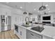 Open kitchen features white cabinets, stainless appliances, and a stone countertops at 9513 Villa Ridge Dr, Las Vegas, NV 89134