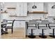 Kitchen features white cabinets, an island with seating, and hardwood floors at 9513 Villa Ridge Dr, Las Vegas, NV 89134