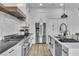 Stylish kitchen featuring stainless steel appliances, white cabinets, and quartz countertop at 9513 Villa Ridge Dr, Las Vegas, NV 89134