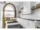 Close-up of a kitchen sink with a gold faucet and window view at 9513 Villa Ridge Dr, Las Vegas, NV 89134