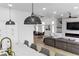 Open concept living space featuring kitchen island, pendant lights, and adjoined living room at 9513 Villa Ridge Dr, Las Vegas, NV 89134