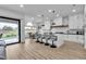 Bright, modern kitchen featuring a large island with bar seating and white cabinetry at 9513 Villa Ridge Dr, Las Vegas, NV 89134