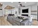 Open-concept living room with modern furnishings, fireplace, and wood-look flooring at 9513 Villa Ridge Dr, Las Vegas, NV 89134