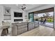 Spacious living room with an electric fireplace, modern furnishings, and sliding glass doors to the patio at 9513 Villa Ridge Dr, Las Vegas, NV 89134