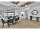 Elegant living space featuring a modern chandelier, wood-look floors, and an open-concept design at 9513 Villa Ridge Dr, Las Vegas, NV 89134