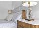 Close-up of a nightstand featuring white marble countertop, a crystal lamp, and a wood-paneled drawer at 9513 Villa Ridge Dr, Las Vegas, NV 89134