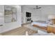 Main bedroom featuring an electric fireplace, ceiling fan, and hardwood floors at 9513 Villa Ridge Dr, Las Vegas, NV 89134