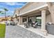 Beautiful covered patio features a dining set, tiled floor, and a built-in outdoor kitchen at 9513 Villa Ridge Dr, Las Vegas, NV 89134