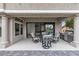 Covered patio features a dining set, tiled floor, and a built-in outdoor kitchen at 9513 Villa Ridge Dr, Las Vegas, NV 89134