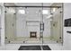 A luxurious shower with dual shower heads, a glass enclosure, and a built-in bench at 9513 Villa Ridge Dr, Las Vegas, NV 89134