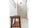 Detailed view of a shower with a wooden bench and a sleek, modern showerhead at 9513 Villa Ridge Dr, Las Vegas, NV 89134