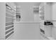Fully equipped walk-in closet with drawers, shelves, and hanging rods for optimal storage at 9513 Villa Ridge Dr, Las Vegas, NV 89134