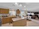 Bright kitchen with island, wooden cabinets, stainless steel appliances, and view into the living room at , North Las Vegas, NV 89031