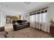 Cozy living room with a comfortable sofa, decorative curtains, and access to the kitchen at , North Las Vegas, NV 89031