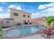 Backyard view showcasing a large pool with rock features and a patio seating area at , North Las Vegas, NV 89031