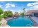 Relaxing pool with rock waterfall feature, palm trees, and patio area at , North Las Vegas, NV 89031