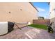 Enclosed backyard featuring a paved patio, green turf, and privacy walls perfect for outdoor activities at 1023 Brilliant Meadow Ave, North Las Vegas, NV 89086
