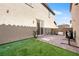 Backyard featuring a paved patio, green turf, and privacy walls perfect for outdoor activities at 1023 Brilliant Meadow Ave, North Las Vegas, NV 89086
