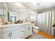 Modern bathroom with double sink vanity, shower with curtain, and modern fixtures at 1023 Brilliant Meadow Ave, North Las Vegas, NV 89086