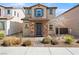 Charming two-story home showcasing stone accents, low maintenance landscaping, and a tiled roof at 1023 Brilliant Meadow Ave, North Las Vegas, NV 89086